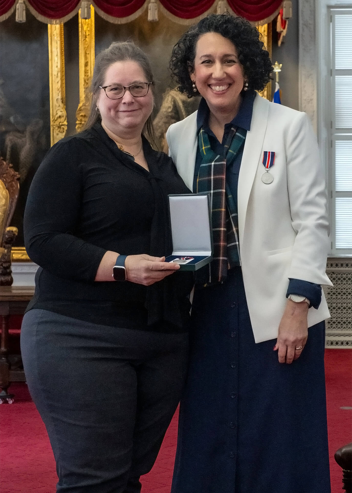 Posing for photo accepting the award.